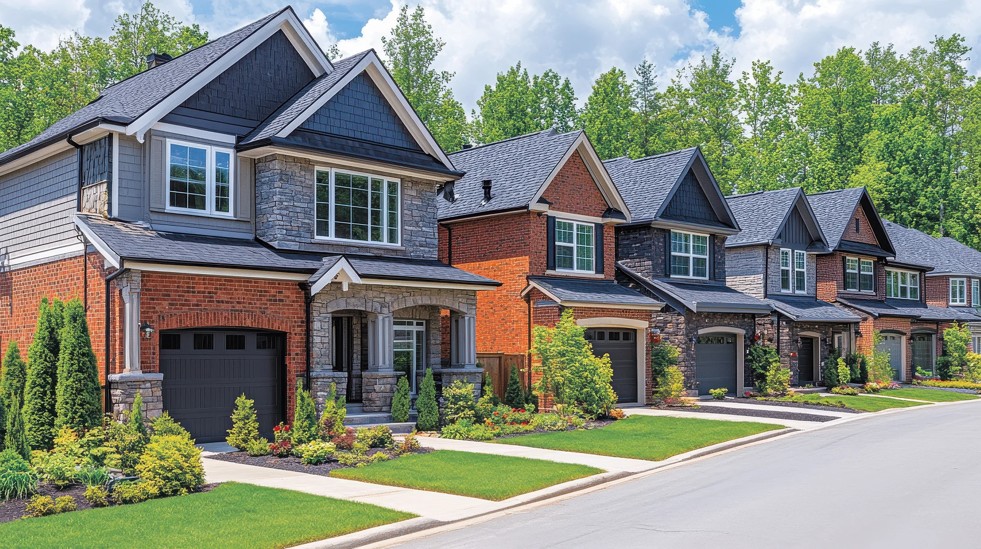 Beautiful suburban street featuring modern homes with well maintained lawns and vibrant landscaping under clear blue sky. scene evokes sense of tranquility and community